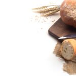 Black coffee and whole wheat bread for breakfast on white background